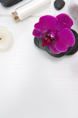 Obraz na płótnie Canvas Spa or wellness setting with pink orchids ,candle and black stones.