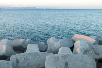 artificial breakwater with the sea in the background