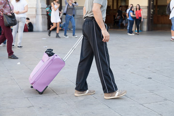 people carrying their suitcase