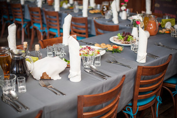 Restaurant banquet table. Wedding party background. Elegant hotel celebration venue. Silverware dinner preparation. Business luxury dining reception.