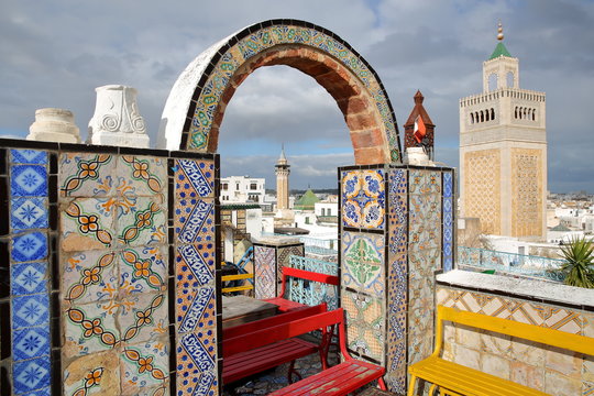 Colorful tiled terrace overlooking the medina in Tunis, Tunisia, with a view on the minaret of Ez Zitouna Mosque (Great Mosque) and the minaret of Hammouda Pacha Mosque