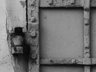 Iron door hinges on an old antique metal gate