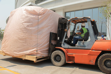 Orange forklift is lifting train head for driving simulation
