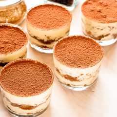 Glass filled with creamy tiramisu and lady fingers