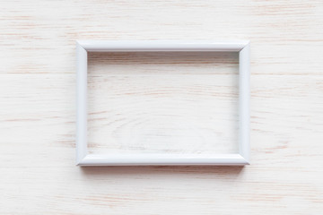 White wooden frame for painting, picture or text on white wooden background