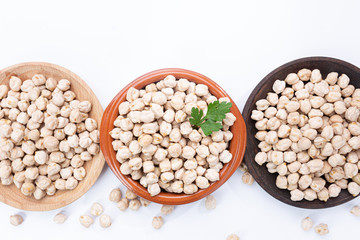 Chickpeas on plates on  white background.