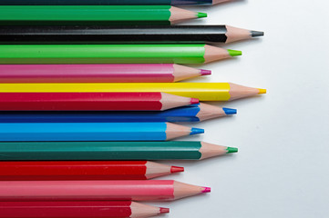 Fototapeta premium multicolored pencils on a white background. top view.