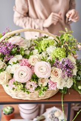 Woman florist creating beautiful bouquet in flower shop. Work in flower shop. Flowers delivery.