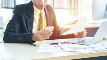 hand asian  businessman using phone in workplace