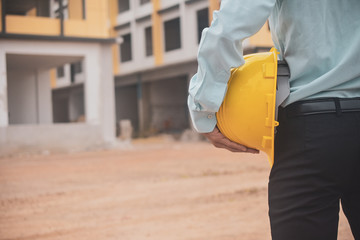 Businessman holding hard hat building estate construction background,Engineer Supervisor  Foreman concept