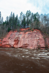 Red cliffs by running river
