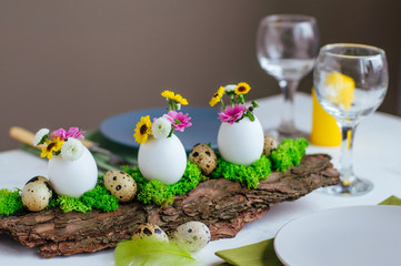 Fototapeta na wymiar Close up of natural decoration for Easter table with eggs and chrysanthemum flowers