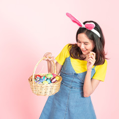 woman wear bunny ears hold easter eggs basket