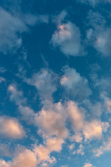 Beautiful evening blue sky with golden clouds as a natural background