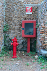 Old street fire hydrant to extinguish a fire in the streets of the antique Italian antique city of Ostia Antica