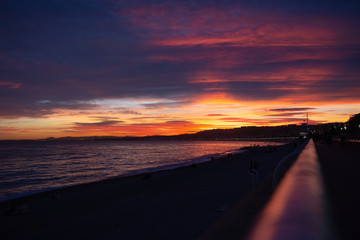 Brilliant beach sunset with colorful pink, orange and blue clouds. Seascape of Nice, Provence, France. Gorgeous sunset. 