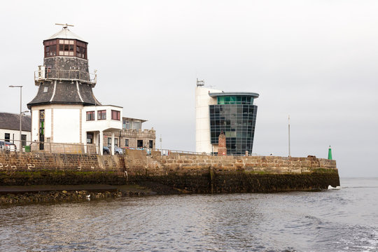 ABERDEEN, SCOTLAND - 2016 MARCH 17. Old roundhouse in Footdee and Aberdeen Harbour Marine Operations Center at the North Pier.