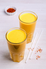 Yellow smoothie in glass