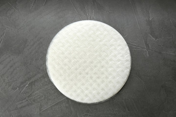 Stack of dry rice paper on grey table, top view