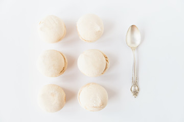The marshmallows with spoon on the white background.Minimalism.Space for text.Flat lay