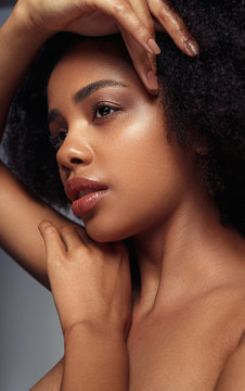 Sensual ethnic model touching face