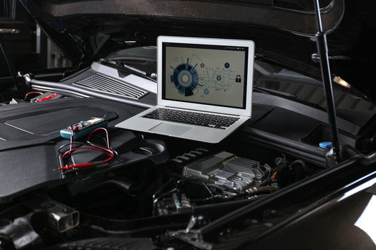 Laptop With Diagram On Auto Engine. Modern Car Diagnostic