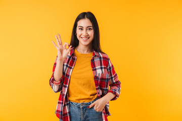 Image of joyful attractive woman smiling and showing ok sign