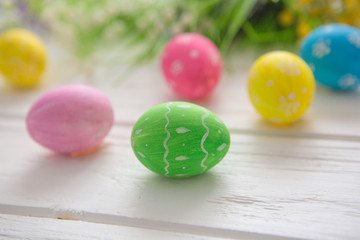 Obraz na płótnie Canvas Easter eggs on a white wooden surface