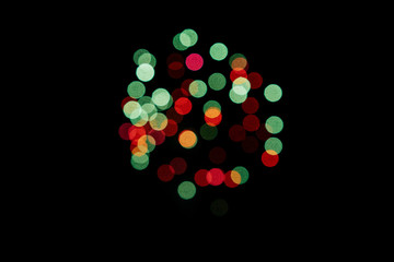Firework of blurred red green lights on a black background. New year concept. Copy space.