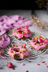 Fototapeta na wymiar Vegan raw raspberry glaze donuts.selective focus.
