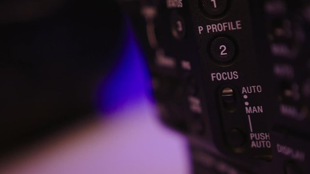 Closeup of the side of professional cinema camera body full of buttons