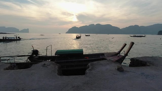 Boats Floating And Sailing Over The Calm Sea In Koh Phi Phi, Thailand At Sunset With Scenic Mountains In The Background - Wide Shot