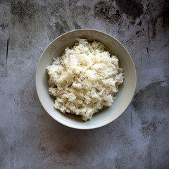 A Bowl of White Rice on a Concrete Bbackground