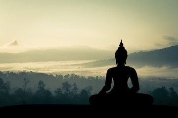 silhouette of buddha at sunset