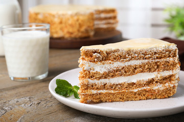 Delicious cake with condensed milk on wooden table, closeup