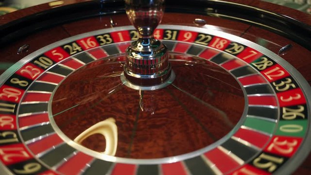 Сasino: roulette in Las Vegas with white ball.  The ball falls on the  field twenty three red. Top view. Close-up. 4K video