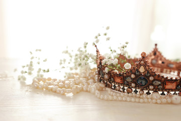 Vintage crown and pearls necklace. Wedding concept. Back light