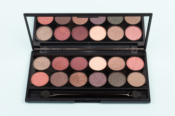 set of pastel eyeshadows isolated on blue background