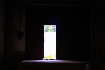 A stream of light through the front door. The view from the tunnel. Close-up.