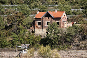 Old ruined railway house made of red bricks
