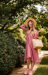 Cheerful female walking in summer park