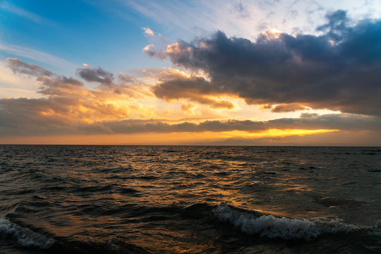 Beautiful landscape. Bright sunset with dramatics clouds over the lake. 