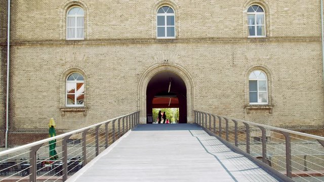 Moving towards Old Building with Open Gate