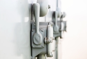 Alarm bells hang on a metal cabinet. Close-up.