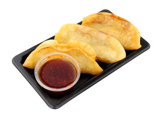 Vegetarian Japanese gyoza snack pack with sweet chilli dipping sauce isolated on a white background
