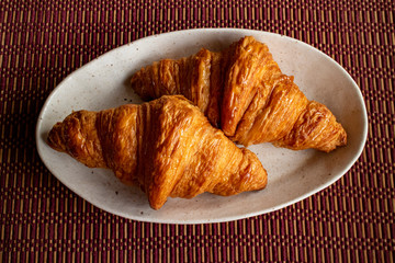 Two delicious croissants on a white plate 4　白い皿にのった美味しそうな二つのクロワッサン
