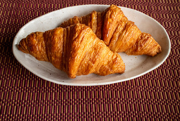 Two delicious croissants on a white plate 3　白い皿にのった美味しそうな二つのクロワッサン
