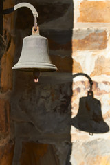 Obraz premium Vintage bell hanging outside and its shadow