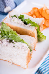 white bread with tuna spread and romaine lettuce served with cheddar potato chips