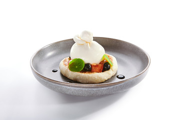 Burrata on rye pita with tomatoes and olives closeup view
